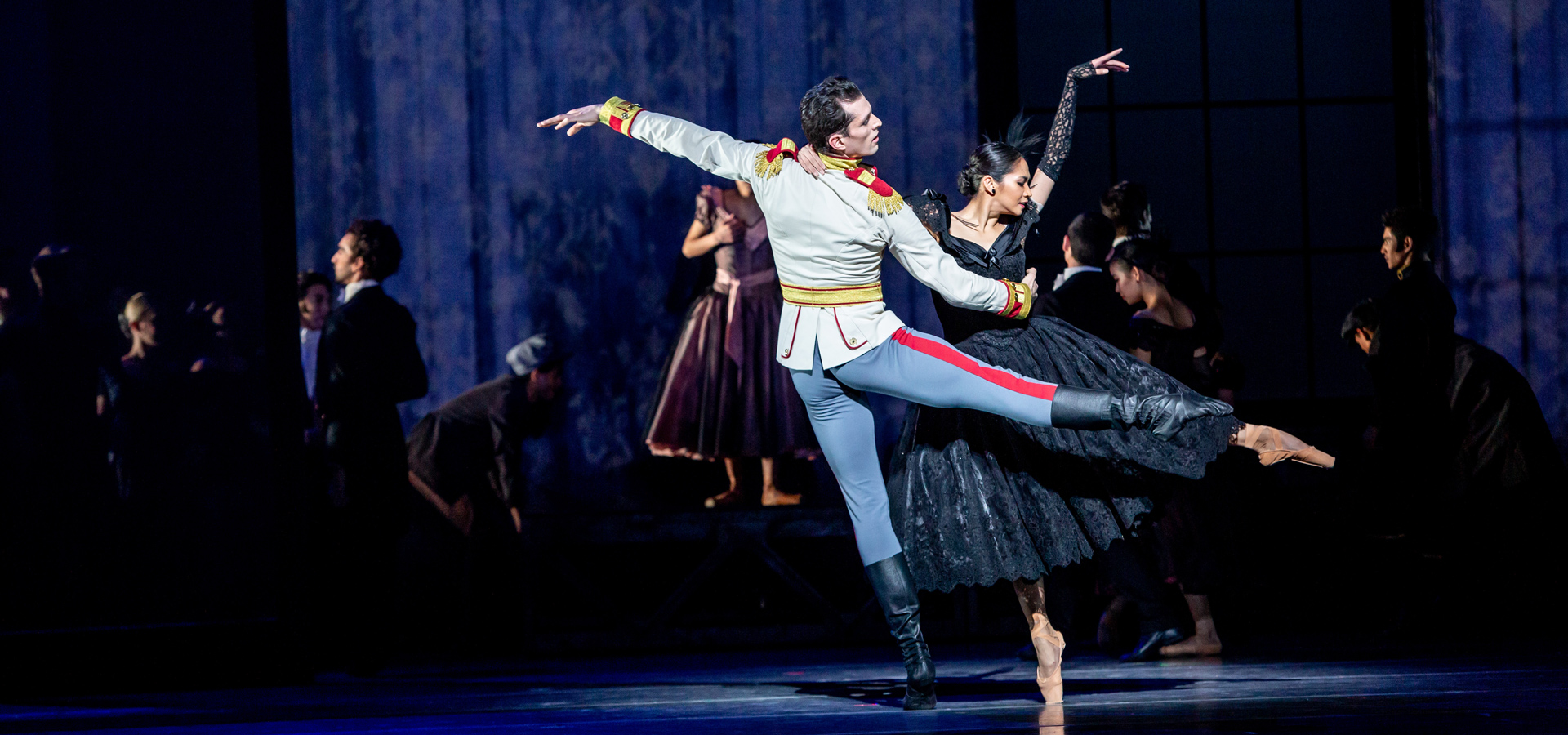 Christine Rocas and Dylan Gutierrez dancing together on stage amidst a performance of Anna Karenina.