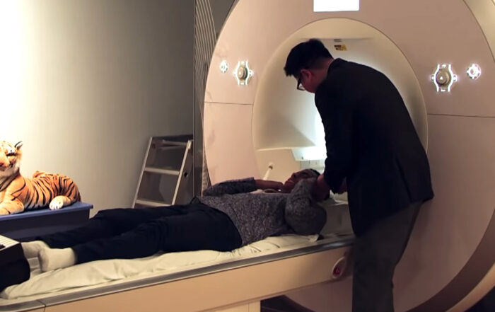 Charles Lamb and Matthew Whitaker near MRI machine