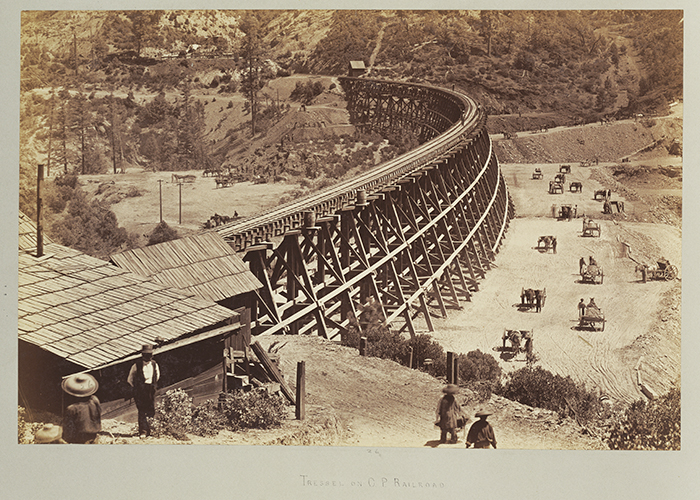 A vintage photograph of an elevated railroad construction as part of the transcontinental railroad.