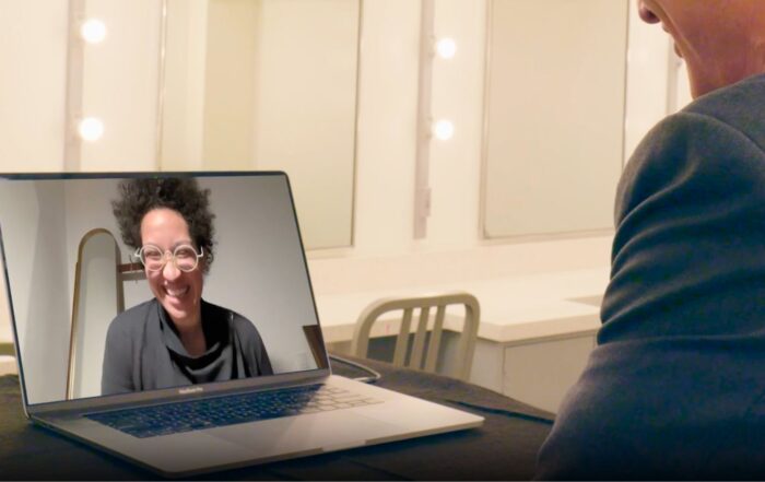 Artist Julia Bullock’s smiling face shown from a video call on a laptop screen.