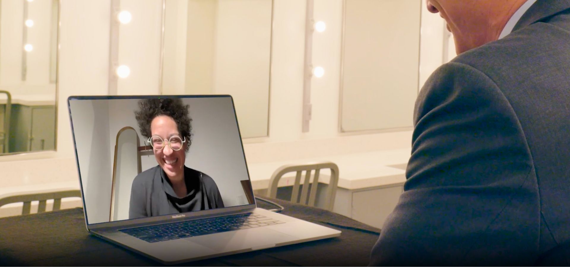 Artist Julia Bullock’s smiling face shown from a video call on a laptop screen.