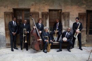Preservation Hall Jazz Band standing with instruments