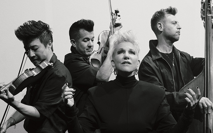 All dressed in black is a group of three men with string instruments -- Time for Three -- and a blond woman, Joyce Didonato
