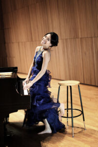 Joyce Yang smiling and happy at the piano