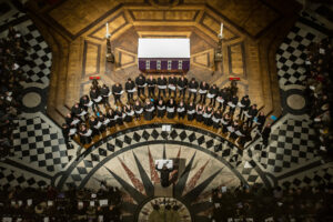 Pictured in an aerial photo, the Tallis Scholars perform inside an ornate church.