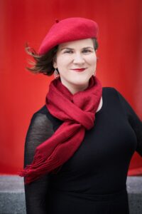Ema Nikolvska wearing a red beret and scarf.