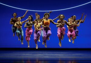 Alvin Ailey dancers doing a synchronized jump pose.