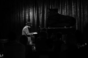 Monochrome photo of Sullivan Fortner playing the piano