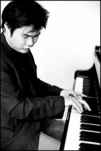 A black-and-white image of Nobuyuki Tsujii playing the piano.