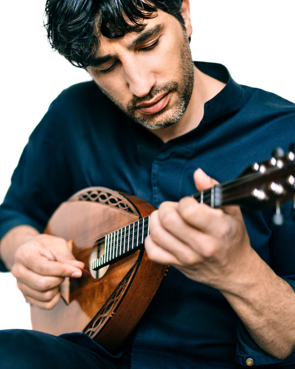 Avi Avital strumming his mandolin.