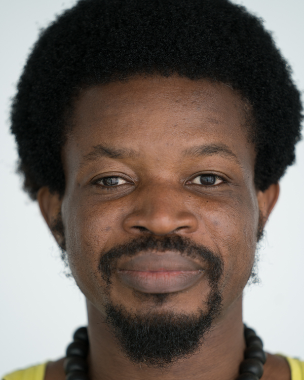 A close up image of artist Florent Nikiema, a middle aged black man with a small afro and goatee.