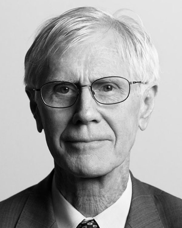 Black and white photo of artist Orville Schell, wearing glasses and a formal suit.