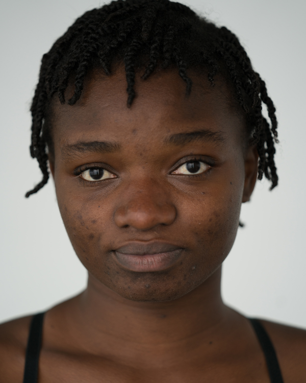 A close up photo of artist Stephanie Mwamba, a young black woman with short twisted hair.