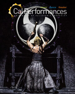 A close up photo of Maxim Venegrov, a middle-aged man wearing a blue velvet jacket and smiling at the camera.