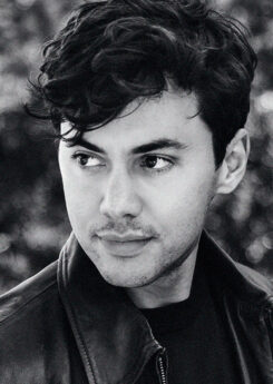 Benjamin beilman, a young man wearing a black leather jacket, gazes off to hte left of hte camera