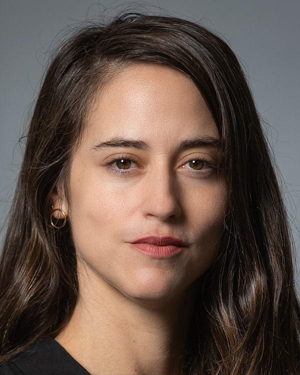 Dr. Lior Avizoor, a light-skinned woman with long dark hair, smiles slightly into the camera