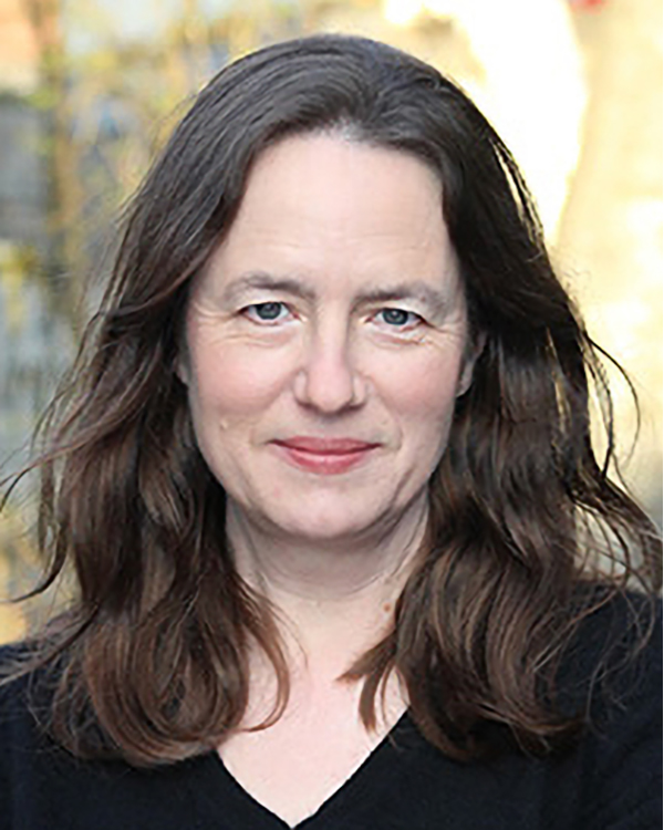 Heather Cox Richardson, a white woman with long, brown wavy hair, looking into the camera