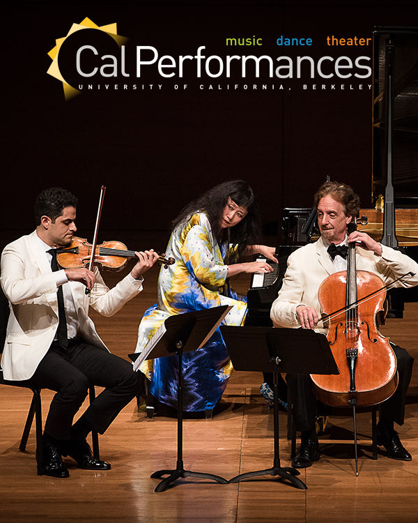 Three musicians performing seated together on stage; Wu Han on piano, David Finckel on cello, and Arnaud Saussman on violin.