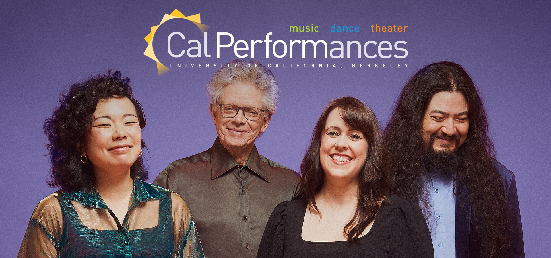 The four members of the Kronos Quartet, two men and two women, wear stand and smile in front of a purple background.