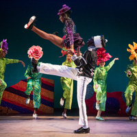 Dancers in colorful flower costumes perform on stage in the Dorrance Dance group's interpretation of Tchaikovsky's Nutcracker Suite.