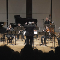 The Eco Ensemble performs a concert on stage in front of an audience.